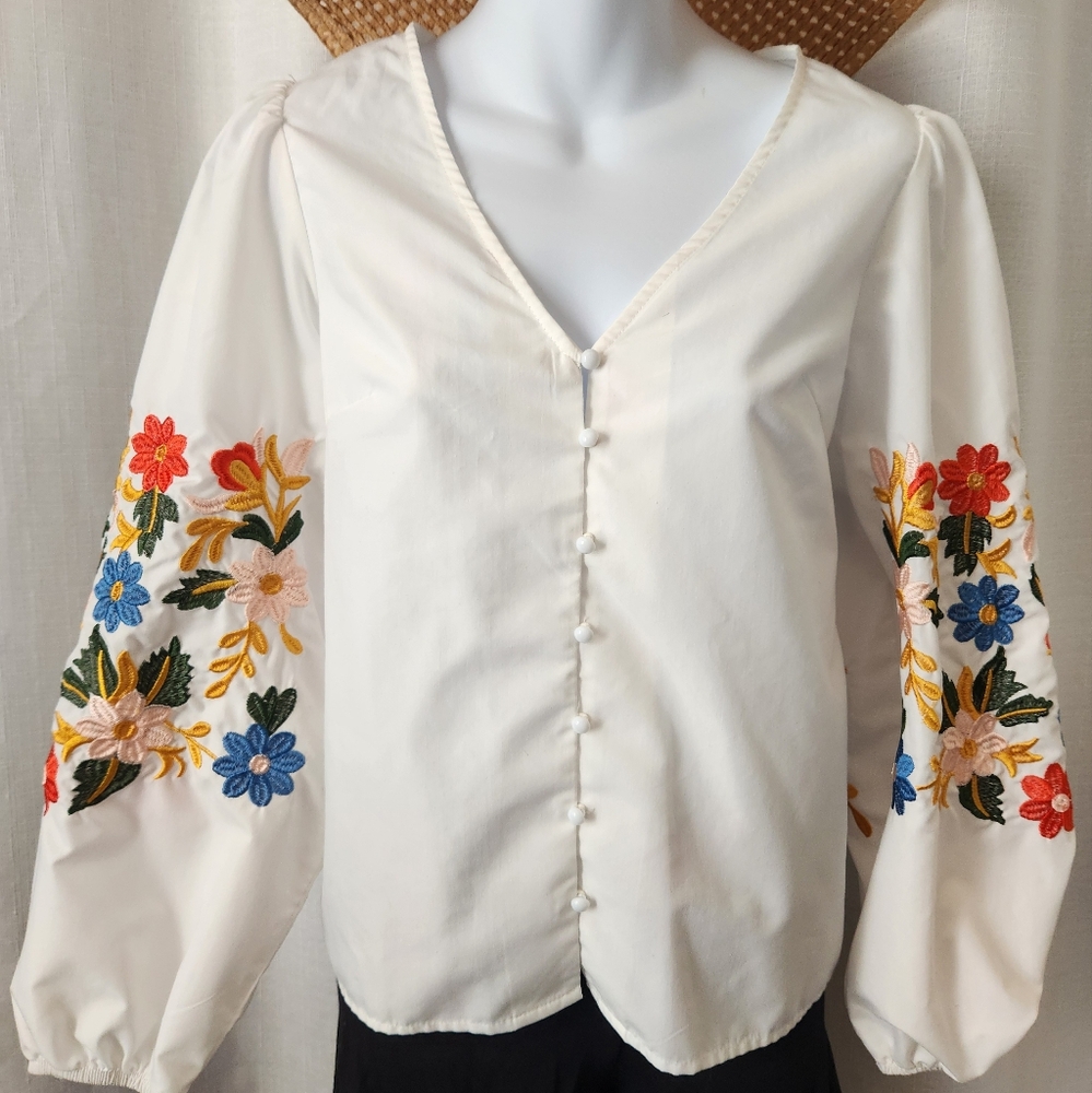 White blouse with embroidered floral sleeves